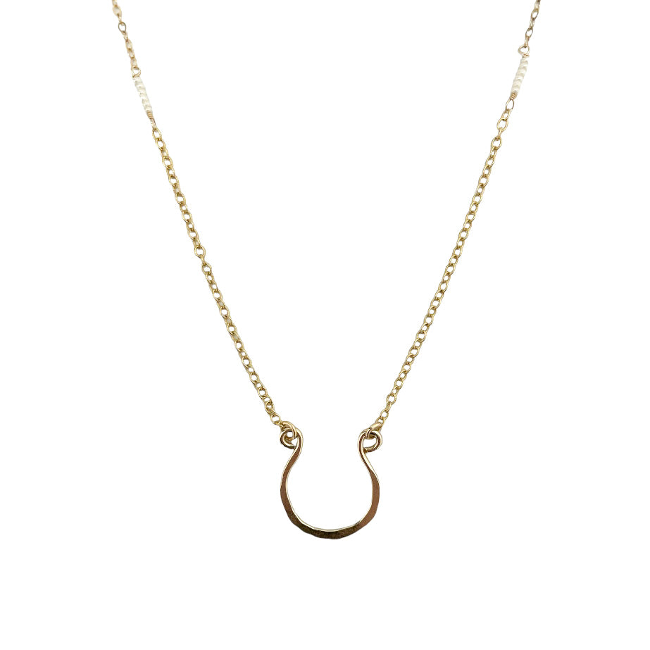 gold-filled horseshoe necklace with tiny pearls